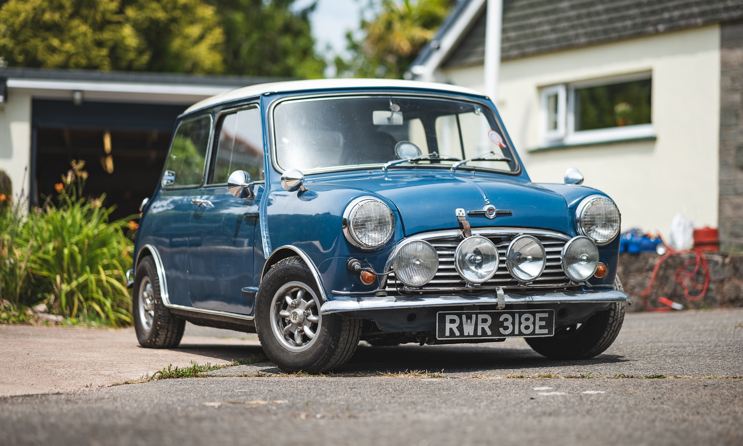 Mini Cooper S in side view, tiny wheels, upright stance, the proportions of something that shouldn't work but does