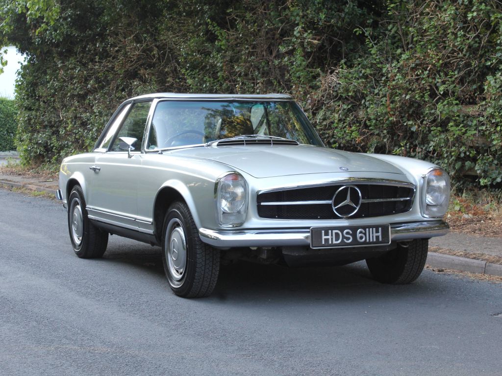 Mercedes W113 280SL Pagoda in side profile, the concave hardtop roof curves down at the centre, giving the car its name